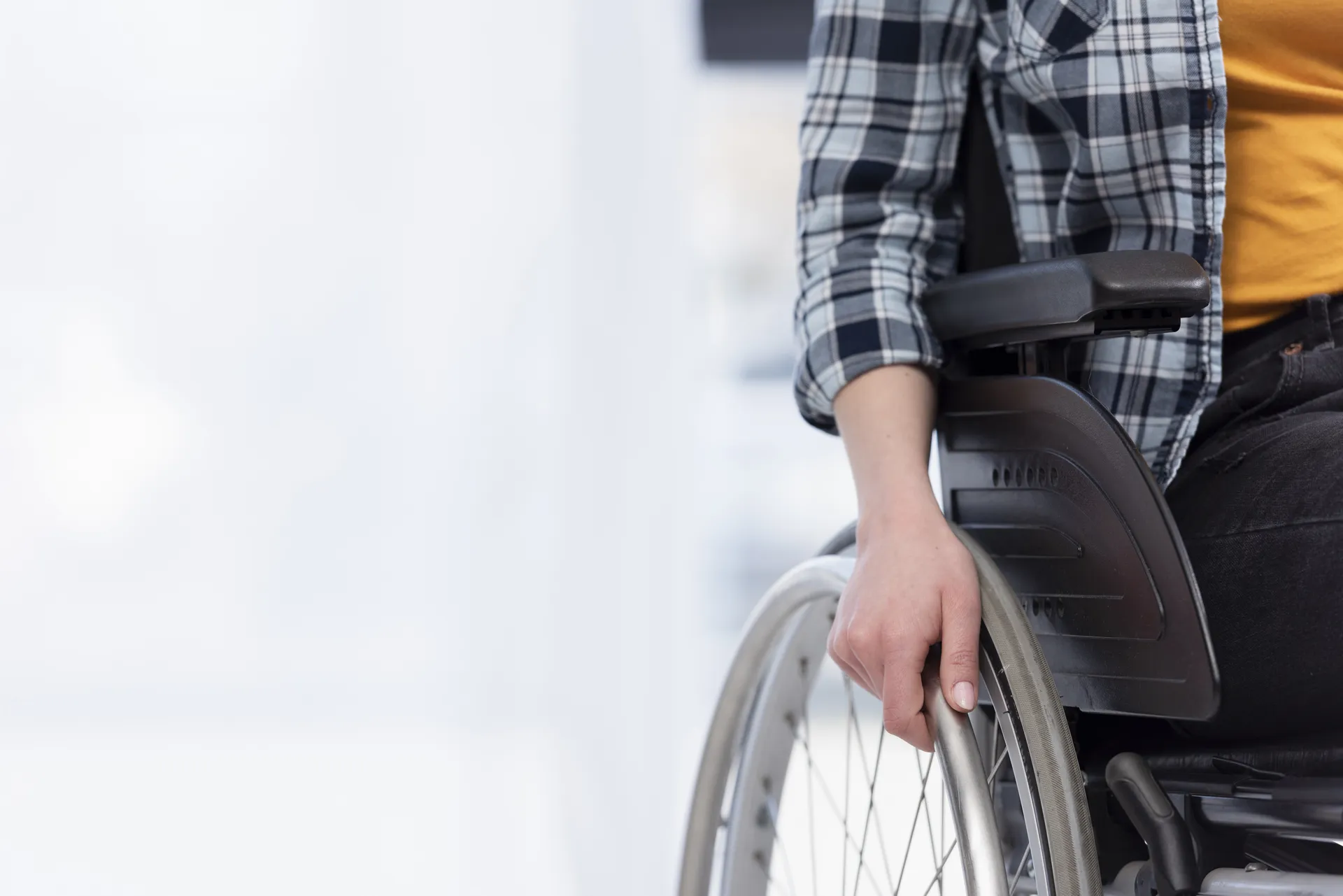 Close-up of a hand on a wheelchair wheel